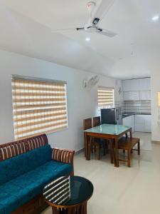 a living room with a couch and a table at Oisca Furusato Village By Le Miste in Vayittiri