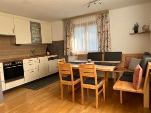 a kitchen and dining room with a table and chairs at Appart Ausblick in Vandans