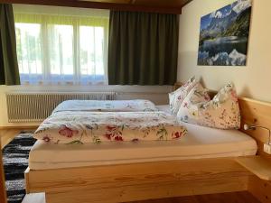 a bedroom with a bed with pillows on it at Appart Ausblick in Vandans