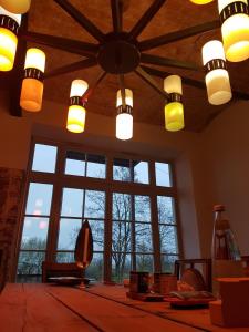 a room with large windows and a ceiling with lights at LOFT in Ribbeck in Nauen