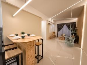 a dining room with a wooden table in a room at Ipoh The Cove Hillside Stay 7 to 10 pax, 5 min to Ipoh Town in Ipoh