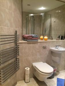 a bathroom with a toilet and a sink and a mirror at A double room in a great location in Southampton