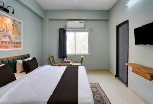 a hotel room with a large bed and a couch at Collection O Kesar Crossway Jaipur Formerly Laxmi Palace in Jaipur +12 photos