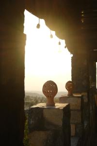 two pots sitting on top of a wall with a window at Al Hudu Mountain House - Jebel Shams in Al Ḩayl