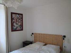 a bedroom with a bed and a picture on the wall at La Mazardie in Cubjac-Auvézère-Val d'Ans