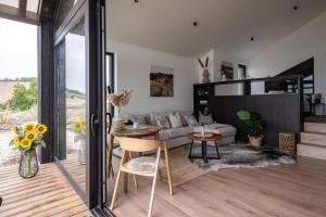 a living room with a couch and a table at Kosa Estate in Štúrovo
