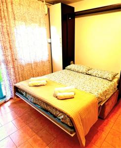 a bedroom with two beds with towels on them at TT House Rho Fiera Milano Station in Rho