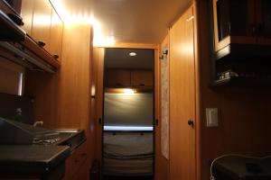 a small room with a door leading into a kitchen at Full Service Caravan 3 in Søborg