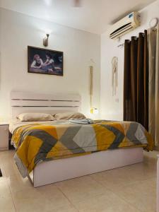 a bedroom with a bed and a picture on the wall at Sea Breeze Bay in Calangute