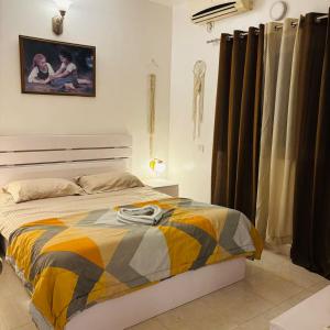 a bedroom with a bed and a painting on the wall at Sea Breeze Bay in Calangute