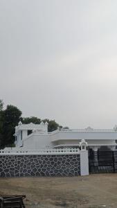 a white building on top of a stone wall at Chitrak stays Jawai in Bijāpur +3 photos