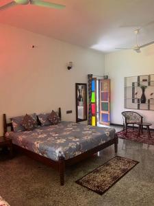 a bedroom with a bed and a couch in a room at Chitrak stays Jawai in Bijāpur