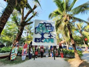 a sign for an exotic resort with surfboards at Debunga Chalet in Teluk Bahang