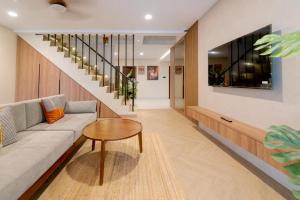 a living room with a couch and a table at Palm Stay Residence in Nagoya