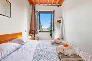 a bedroom with two beds with towels on them at Casa Chopin - ToscanaOneHH in Laiatico +22 photos