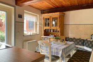 a kitchen with a table and chairs in a room at Stamp, Hafenstraße in Wyk auf Föhr +25 photos