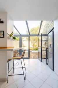 a kitchen with a table and a chair at Cozy 2 bedroom house - 4 people in Bourg-Saint-Andéol