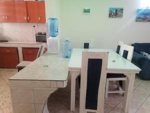 a kitchen with a white table with blue bottles on it at La Grande Cosy 1 Bedroom Ensuite Mtwapa in Mtwapa +17 photos