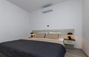 a bedroom with a large bed and two lamps at Villa Klara - Makarska by Villas Guide in Vrgorac +37 photos