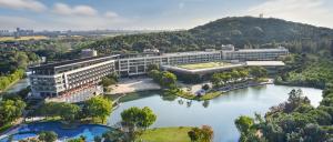 an aerial view of a large building on a river at Le Méridien Shanghai Sheshan in Songjiang