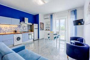 a blue living room with a couch and a table at La pioggia nel pineto in Gaeta