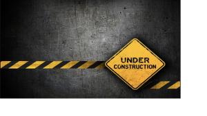 a yellow sign with the words under construction at L'intime in Dingsheim