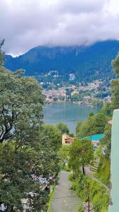 a view of a body of water with a mountain at Izna's stay in Nainital