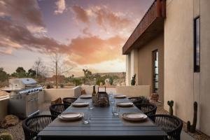 a long table on a patio with a view of the desert at Windsong Modern compound w pool spa in Yucca Valley