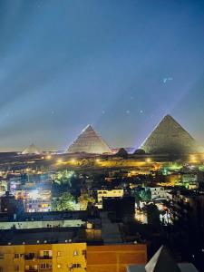 a view of the pyramids of giza at night at AB pyramids view in Cairo
