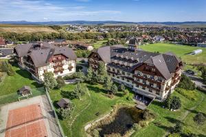an aerial view of a large building with a yard at Apartment Katry with Tatry View & Balcony in Veľká Lomnica