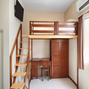 a small room with a bunk bed and a desk at Nuasana Living Dukuh Kupang Barat in Surabaya