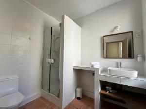 a white bathroom with a sink and a shower at l espérandieu in Marseille +20 photos