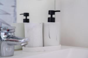 two rolls of toilet paper sitting next to a sink at Heaven Loft - proche RER A - DISNEY LAND in Bussy-Saint-Georges +25 photos