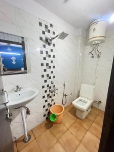 a bathroom with a sink and a toilet at Hotel Seven Malviya Nagar in New Delhi