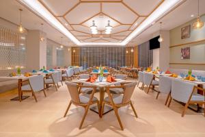 a restaurant with tables and chairs and a ceiling at Park Inn by Radisson Lucknow Vikas Nagar in Lucknow +44 photos
