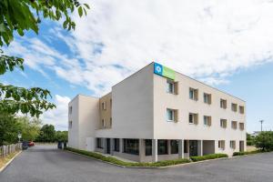 a white building with a sign on the side at Sure Hotel By Best Western Guerande in Guérande