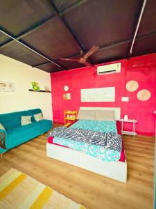 a bedroom with a bed and a red wall at Hosh posh villa in Hyderabad