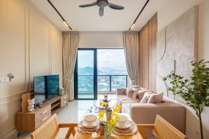 a living room with a couch and a tv at Premium Classy 4Room@Astoria Ampang 12pax 6km KLCC in Kuala Lumpur