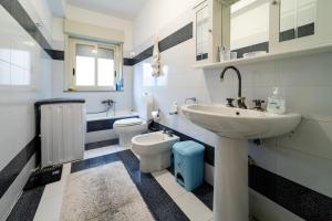 a white bathroom with a sink and a toilet at Il Noccioleto in Linguaglossa +21 photos
