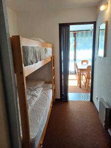 a bedroom with two bunk beds and a dining room at Col de Rousset - App. 2 P in Rousset