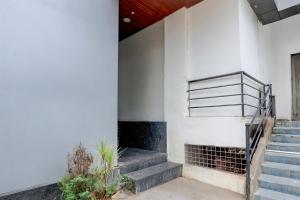 a set of stairs in a building with a stair case at FabHotel Silver Cloud in Warangal