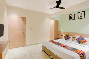 a bedroom with a bed and a ceiling fan at FabHotel Silver Cloud in Warangal