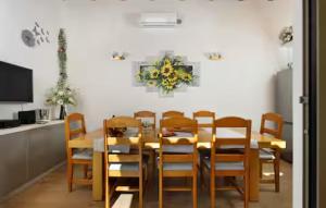 a dining room with a wooden table and chairs at Holiday home Lisnjak by Villas Guide in Trbounje