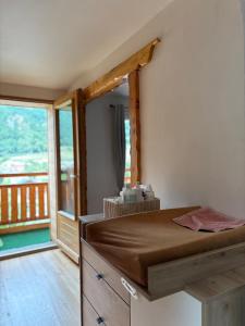 a bedroom with a bed and a balcony at Le montagnard in Le Monêtier-les-Bains