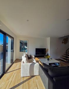 a living room with a couch and a table at Maison avec piscine - Ti Kiff in Plouescat