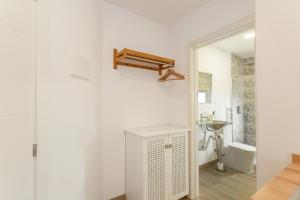 a white bathroom with a sink and a toilet at Bastion del Drago in Arucas +98 photos