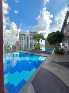 a large swimming pool on the roof of a building at Majestic Residence Klcc by Like Home in Kuala Lumpur