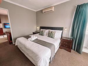 Ένα ή περισσότερα κρεβάτια σε δωμάτιο στο Ilanga Du Cap Hotel