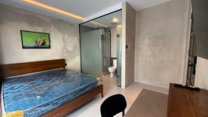 a bedroom with a bed and a toilet in it at Palm Stay Residence in Nagoya