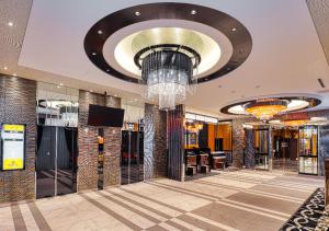 a lobby with a chandelier in a building at APA Hotel Morioka Ekimae in Morioka